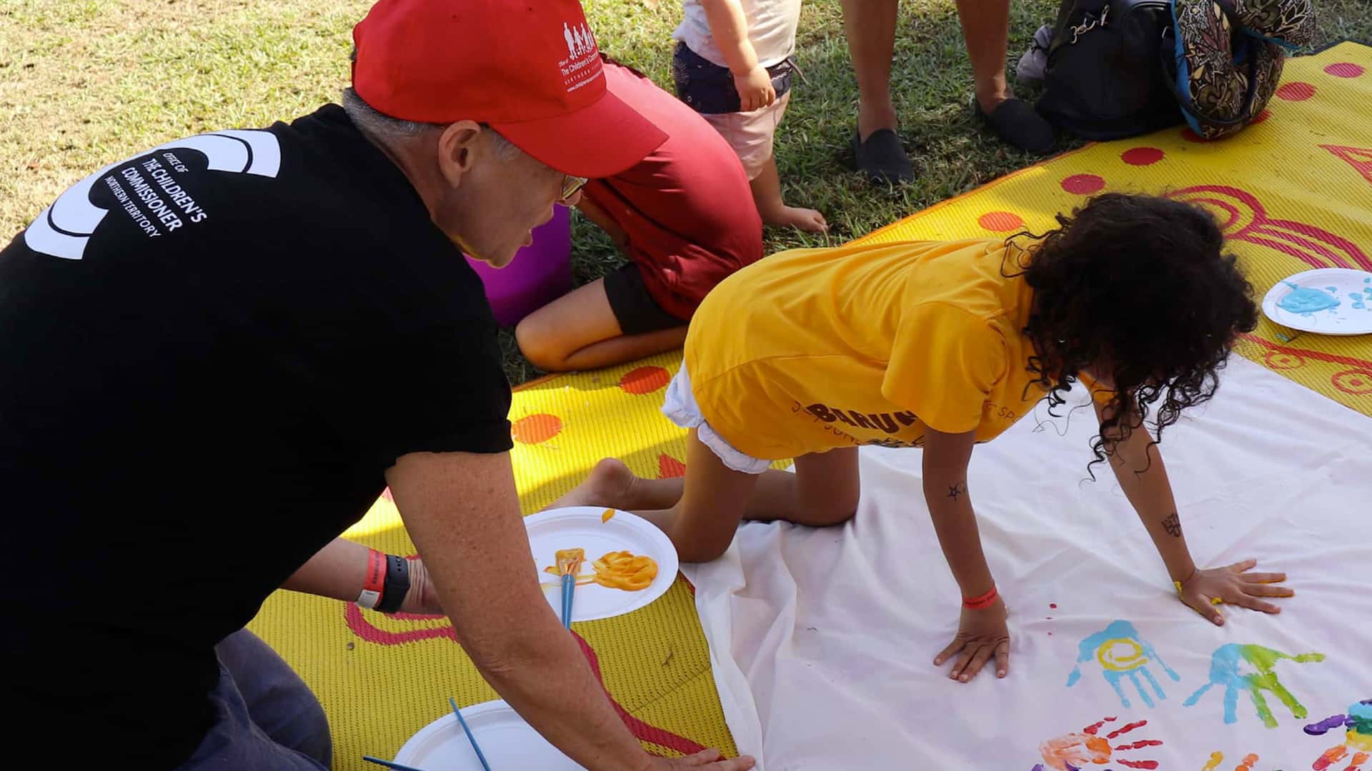 Children making a banner with paint on hands